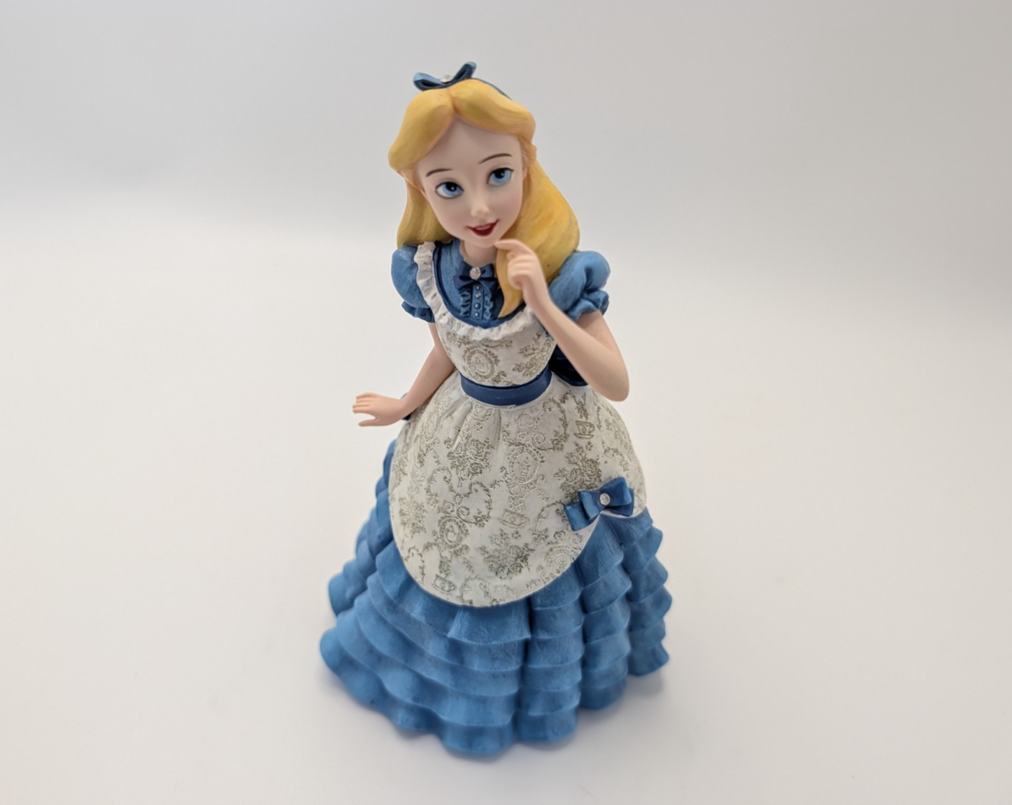 Alternate view of Disney Showcase Alice figurine 6001660 with disclosed fingertip damage