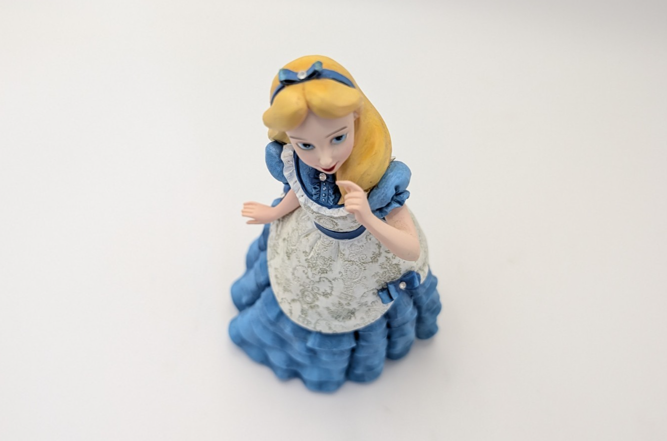 Alternate view of Disney Showcase Alice figurine 6001660 with disclosed fingertip damage