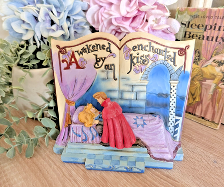 Disney Traditions Enchanted Kiss Aurora and Prince Phillip storybook figurine boxed front view