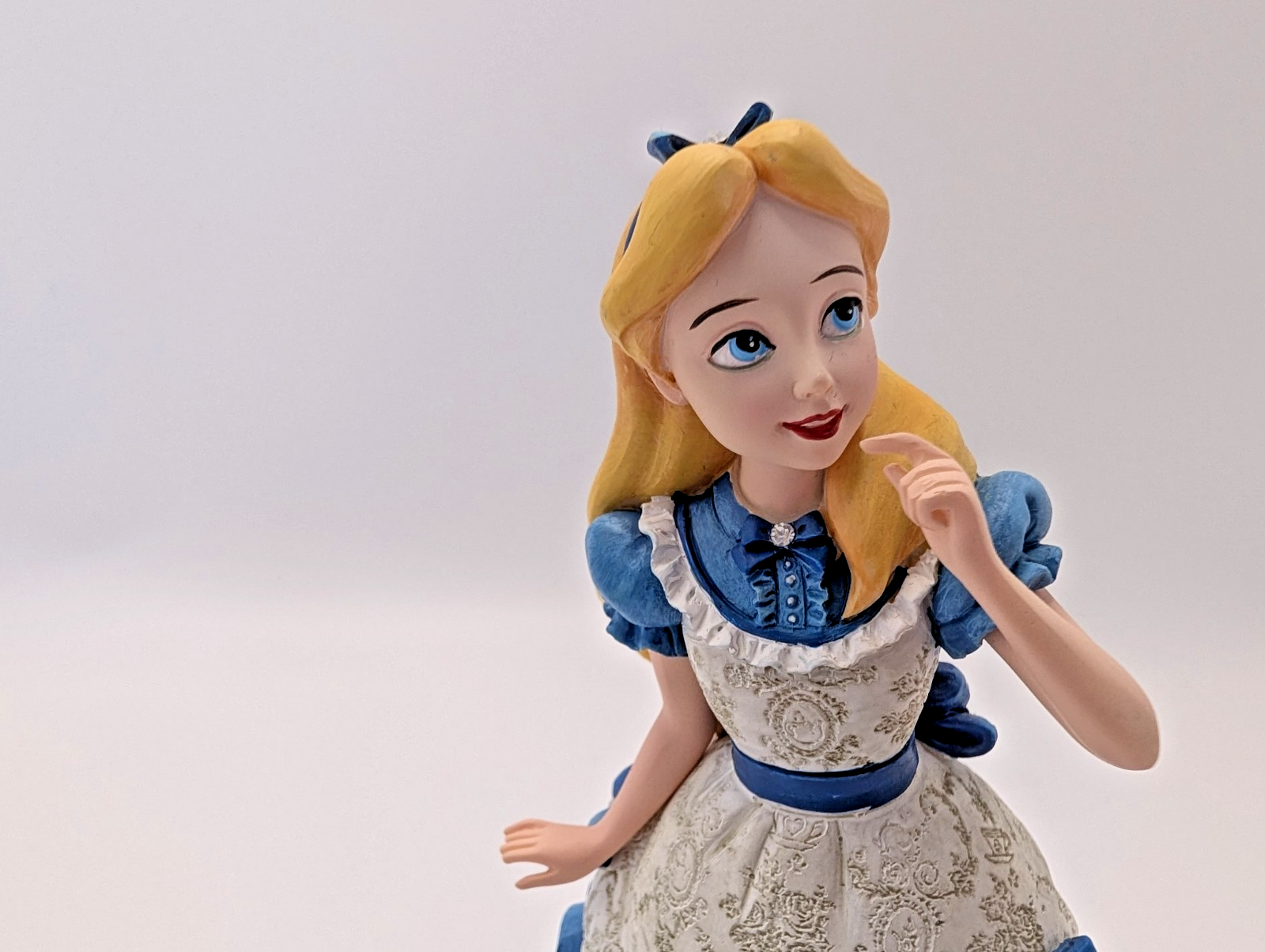 Alternate view of Disney Showcase Alice figurine 6001660 with disclosed fingertip damage