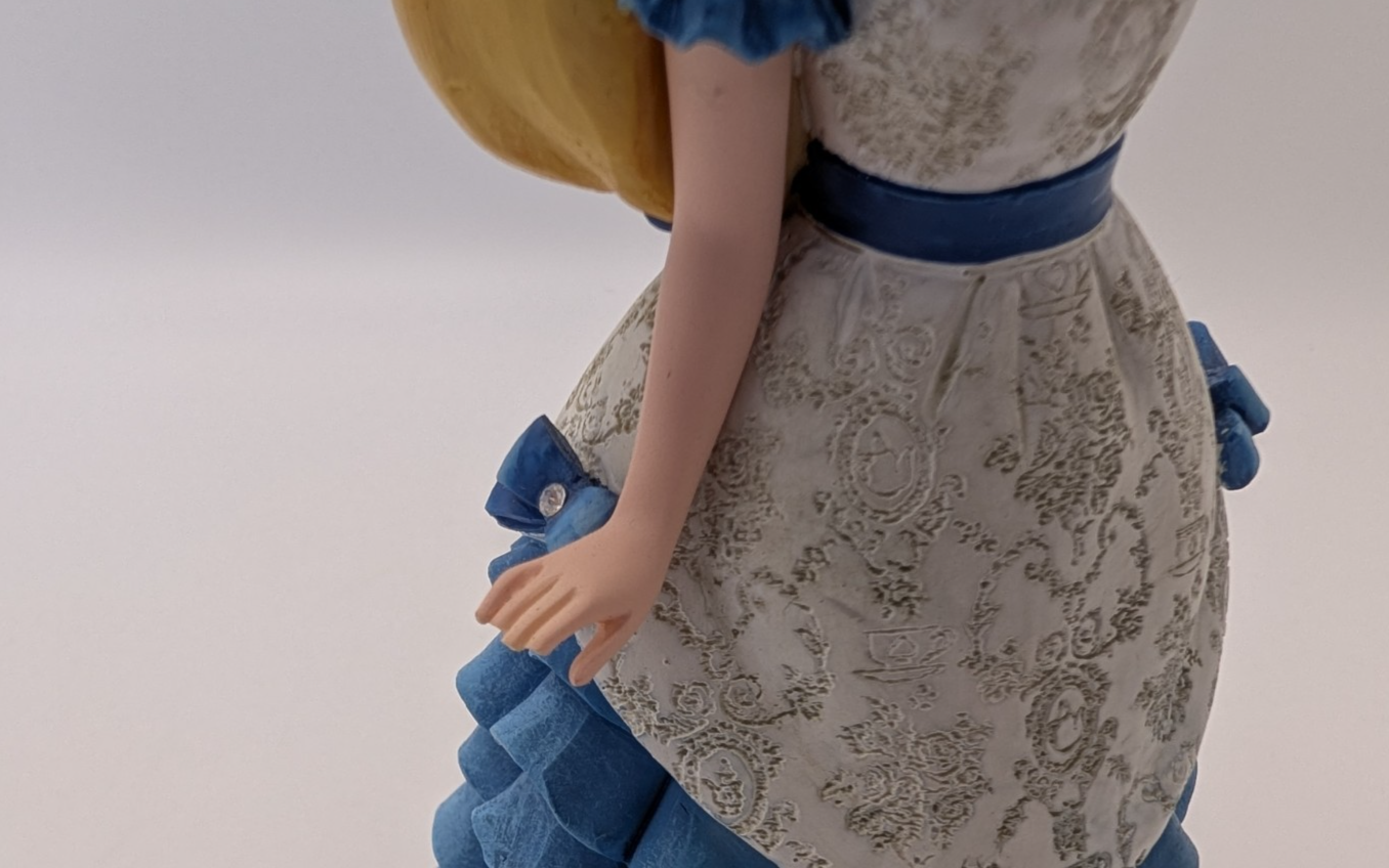 Alternate view of Disney Showcase Alice figurine 6001660 with disclosed fingertip damage