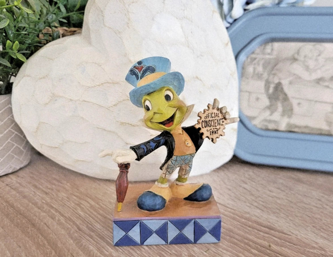 Disney character figurine on a wooden base with decorative elements