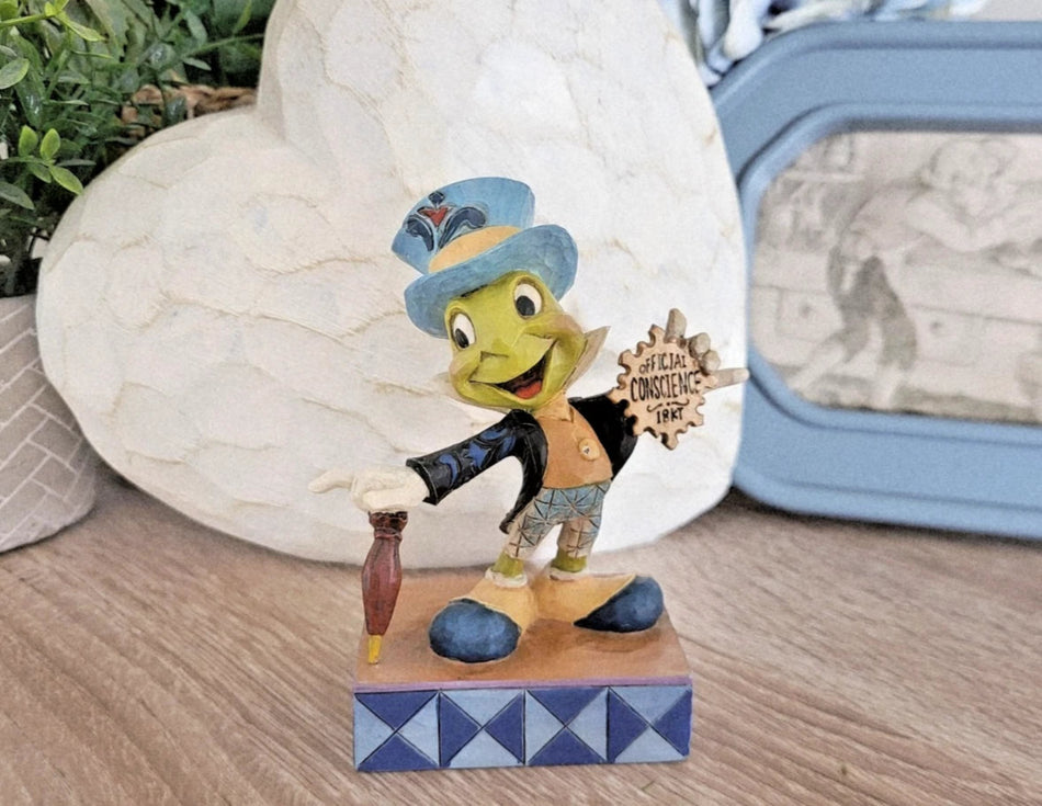 Disney character figurine on a wooden base with decorative elements